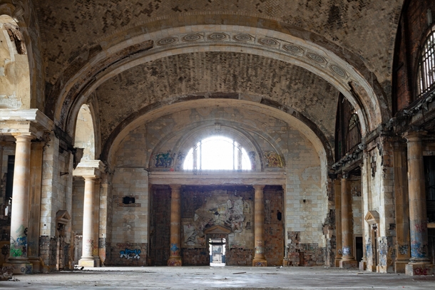 The waiting room of Detroits former train station Michigan Central Station Modeled after an ancient Roman bathhouse with Guastavino tile vaults marble floors bronze chandeliers -foot Corinthian columns 