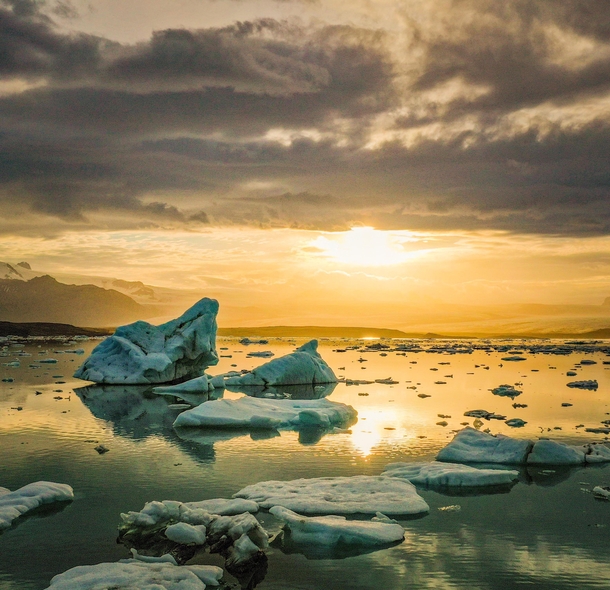 The warm sunset contrasting with the cold ice in a glacier lagoon in Iceland  - IG glacionaut