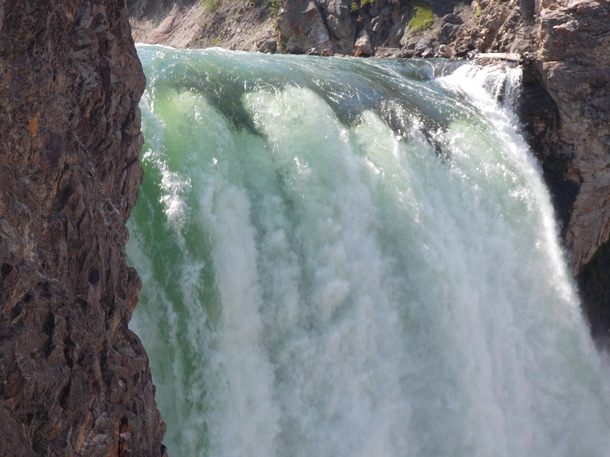 The water of the Yellowstone River falling over the brink of Lower Falls 