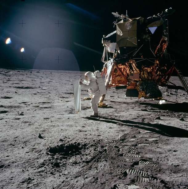 This bright sunlight glints amp long dark shadows marks of lunar surface is taken by Apollo  astronaut Neil Armstrong in July   In the image the spacesuited lunar module pilot Buzz Aldrin is unfurling a long sheet of foil known as solar wind composition e