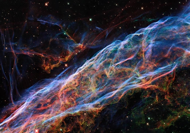 This image taken by the NASAESA Hubble Space Telescope revisits the Veil Nebula In this image new processing techniques have been applied bringing out fine details of the nebulas delicate threads and filaments of ionized gas