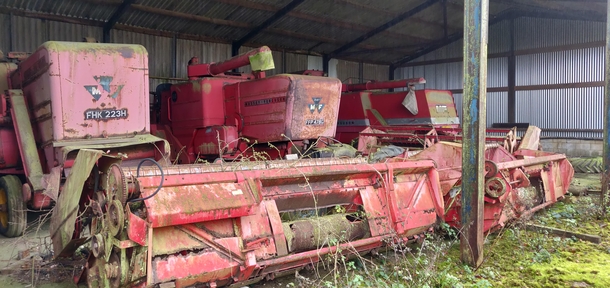 Three abandoned combine harvesters at an abandoned farm Buckinghamshire England
