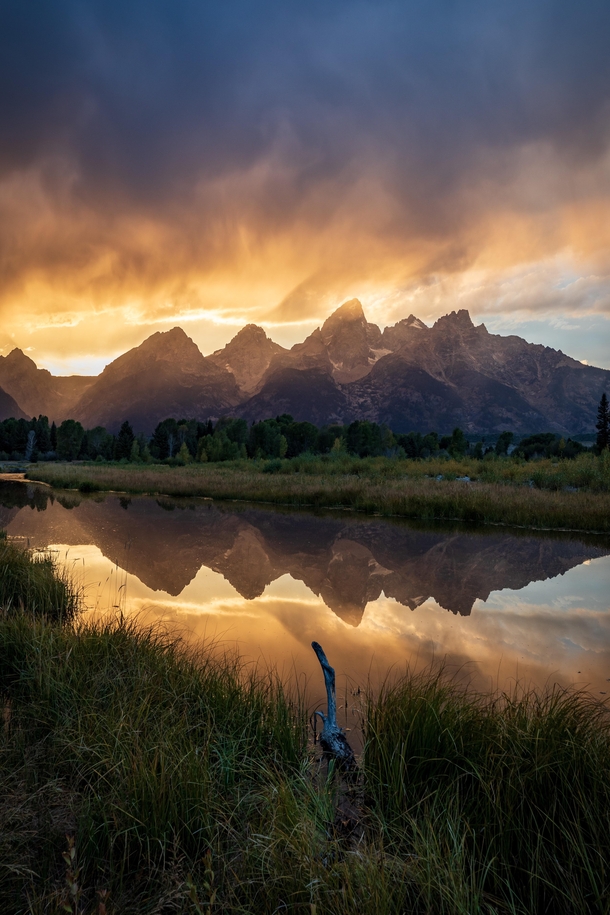 Thunderstorms were all around me echoing in the distance but it remained calm where I was standing creating an ominous sky and reflection - Grand Teton National Park -  IG travlonghorns