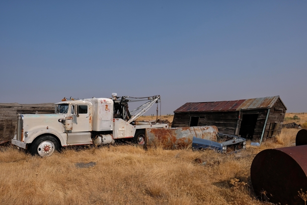 Tow truck sits in a field in Eastern Oregon 