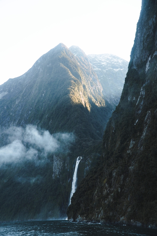 Towering peaks and waterfalls of Milford Sound New Zealand 