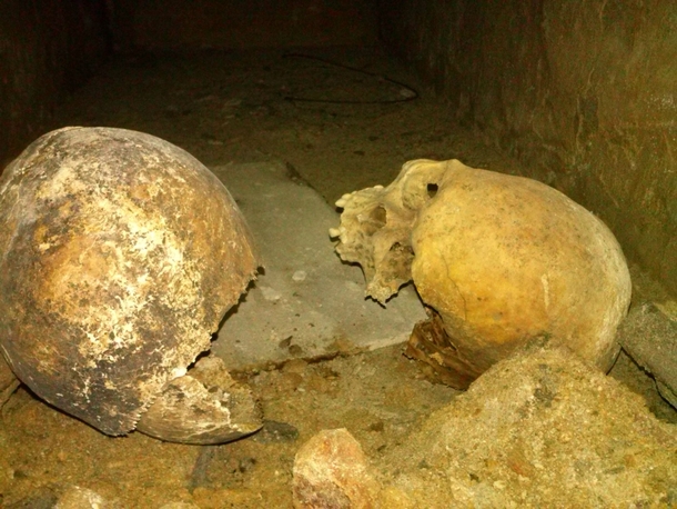 Two broken skulls left in a no longer used tomb in a small ossuary Pisa Italy 