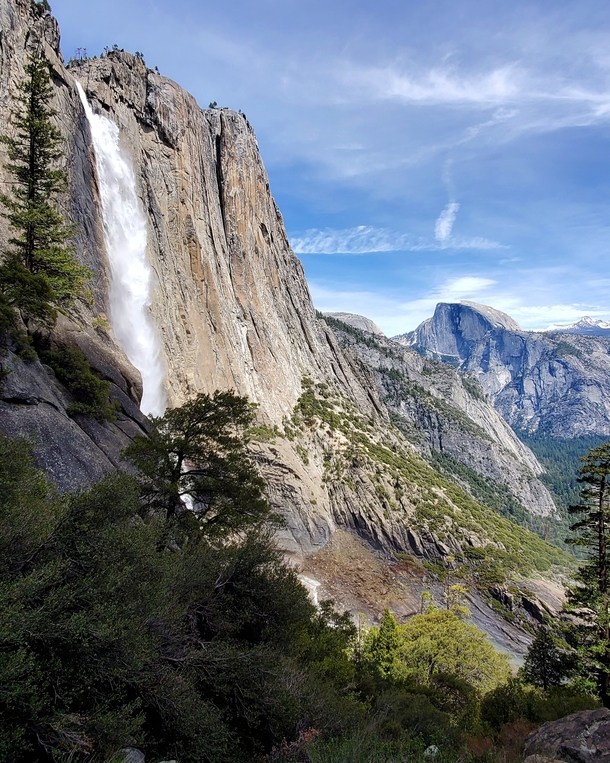 Upper Yosemite Falls with Half Dome making an appearance Yosemite National Park CA USA 