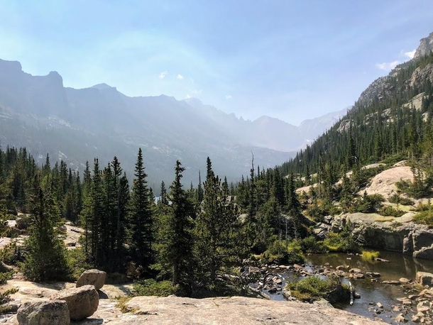 View from Black Lake looking down Glacier Gorge with haze from wildfires Rocky Mountain National Park Colorado USA 