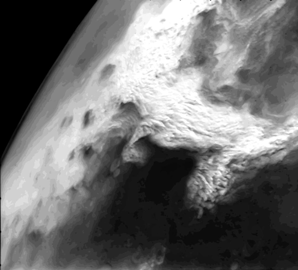 Viking  Orbiter image that shows a large dust storm over the Thaumasia region on Mars This large disturbance soon grew into the first global dust storm observed by the Viking Orbiters 