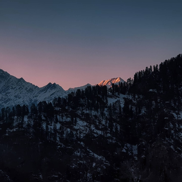 Village of Sethan Himachal Pradesh India A beautiful sunset over the snow peaked mountains 