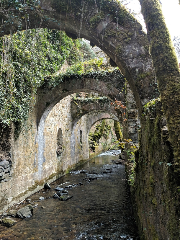 Waterway underneath an ancient ironworks Pyrenees Mountains Spain 