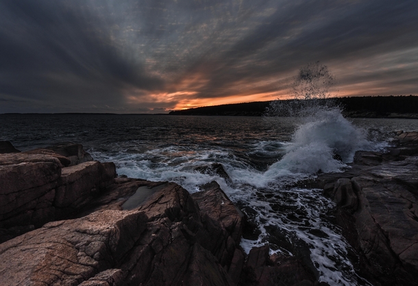 Waves crash against the rocky shores of Otter Point Acadia National Park 