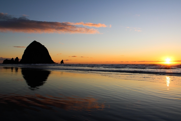 Wet sand mirroring the sunset sky at Haystack Rock Cannon Beach OR 