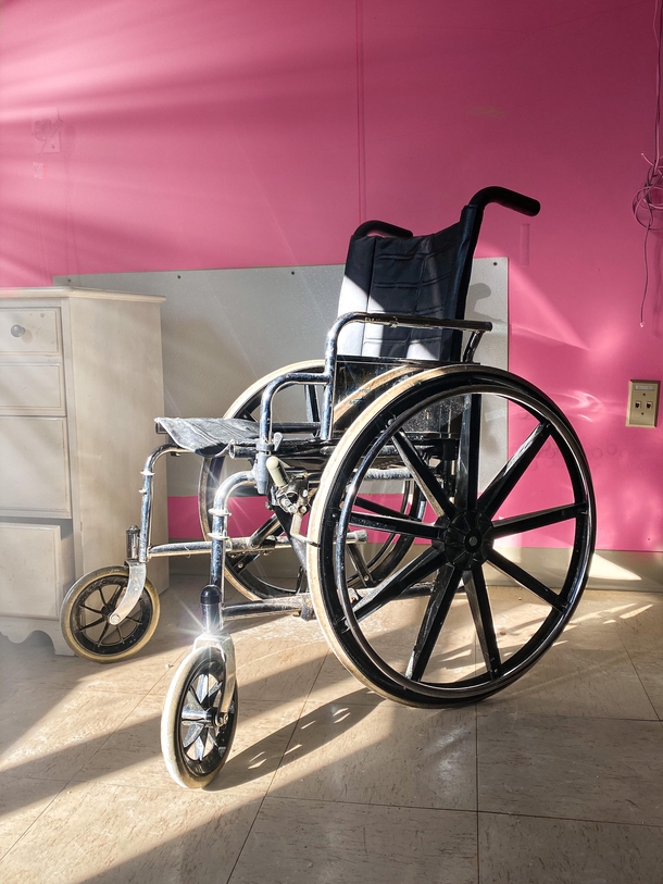 Wheelchair in a recently abandoned psychiatric center IG austinschacht
