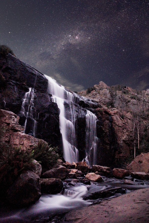 While camping at the Grampians National Park in Australia I captured this scene just before the full moon rose behind the falls 