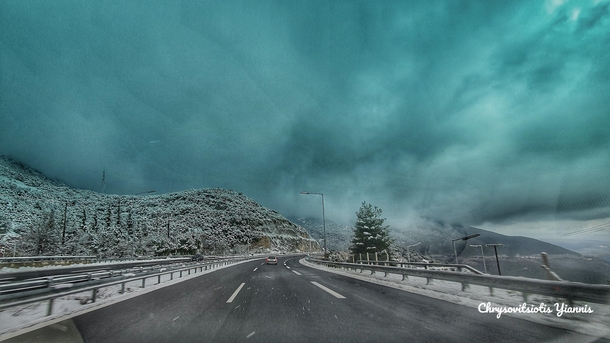 While driving just outside Tripoli Greece I was faced with a magnificent scenery of a snowstorm