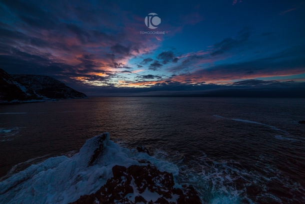 Winter sunset over the frigid Atlantic Ocean from Newfoundland Bottle Cove Newfoundland Canada 