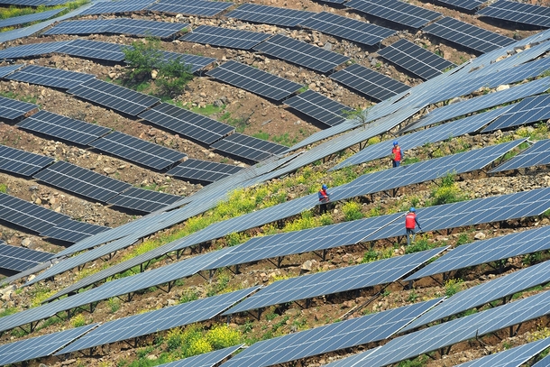 Workers check on solar panels in Chuzhou Anhui province China on April   