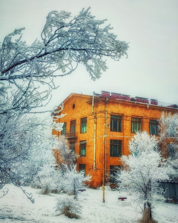 Yellow building surrounded with snow Yerevan