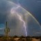 Lightning strikes in front of a rainbow in a southern Arizona desert 