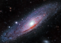  Million light-years away from earth this is the Andromeda Galaxy This image is comprised of  main images each taking many hours to complete This allows you to see the pockets of Hydrogen Alpha in the galaxy and all the fine details