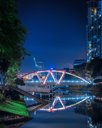 A bridge and calm waters at midnight Singapore