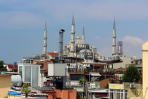 A chimney stands tall among the minarets of the Blue Mosque in Istanbul Turkey 