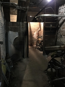 A coal room and furnace turned storage in an old garage