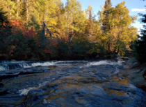 A cold stream flowing in a forest painted with autumnal color - shot two years ago somewhere in the Canadian Shield 