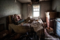 A decaying bedroom at Catskill Game Farm featuring what is most likely a haunted doll 
