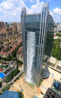 A -foot waterfall cascades down the side of the Liebian Building in Guiyang City China 