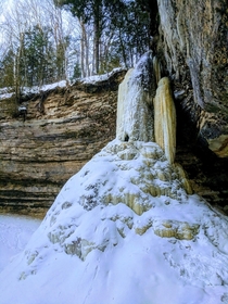 A frozen waterfall that I photographed near Munising Michigan You could still hear water flowing through the hollow tube of ice 