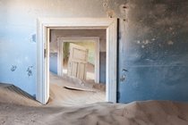A house overrun with sand in Kolmanskop Namibias largest ghost town  Photographed by Monique van der Hoeven