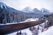 A long exposure of a train making its way through the Canadian Rockies  Photographed by Vicki Mar