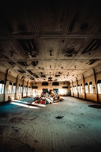 A massive pile of trash sits in the center of a historic abandoned auditorium in Cleveland OH 