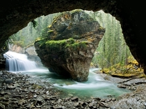 A massive rock anchors a creek in Johnston Canyon in Canadas Banff National Park 