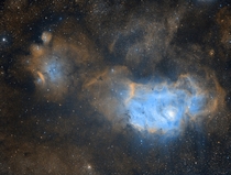 A narrowband of Messier  This wider field of view allows the much smaller emissionreflection nebulas NGC  and Simeis  to be imaged in the same frame The dominant colors here are from hydrogen and sulphur emissions  Image Credit Dylan ODonnell