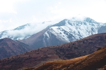 A nice contrast of snow against golden hills in Almaty Kazakhstan 