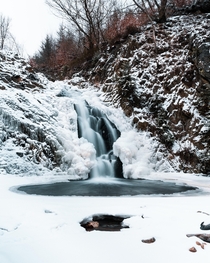 A partly frozen waterfall in Belgium Cascade de Bayehon 