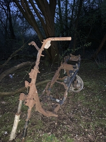 A random abandoned burnt out moped found in the woods Warrington Great Sankey UK