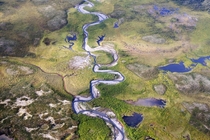 A river runs through a valley near Moose Pond in Canadas Northwest Territories Unknown Photographer 