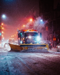 A snow plow clears the road in Toronto Canada  