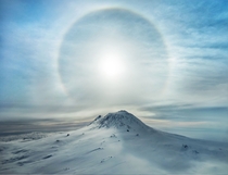 A solar sun bow made up that word over Antarctica and Mt Erebus volcano 