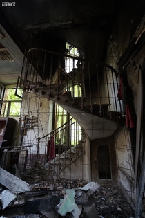 A staircase is almost all that is left after the fire in this manor house