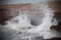 A still of a wave hitting the shores Tiracol fort Goa India