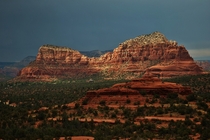 A storm rolls in behind the red rocks of Sedona Arizona 