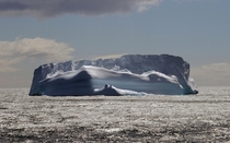 A tabular iceberg floats in the Southern Ocean a few miles from South Georgia Island Formerly a whaling station the island is now an Antarctic research center Sue Volek 