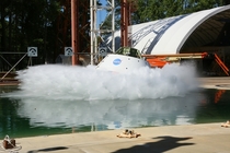A test version of the Orion spacecraft is pulled back like a pendulum and released taking a dive into the -foot-deep  meters Hydro Impact Basin at NASAs Langley Research Center in Hampton Virginia 