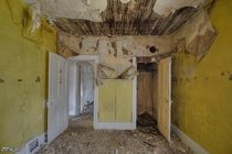 A Very Yellow Bedroom Inside a Very Decayed Abandoned House 