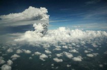 A view from a domestic flight from Denpasar to Yogyakarta that was subsequently diverted to Surabaya airport shows a plume of gas and ash billowing some  km six mi high from Mount Merapi during an eruption on November   